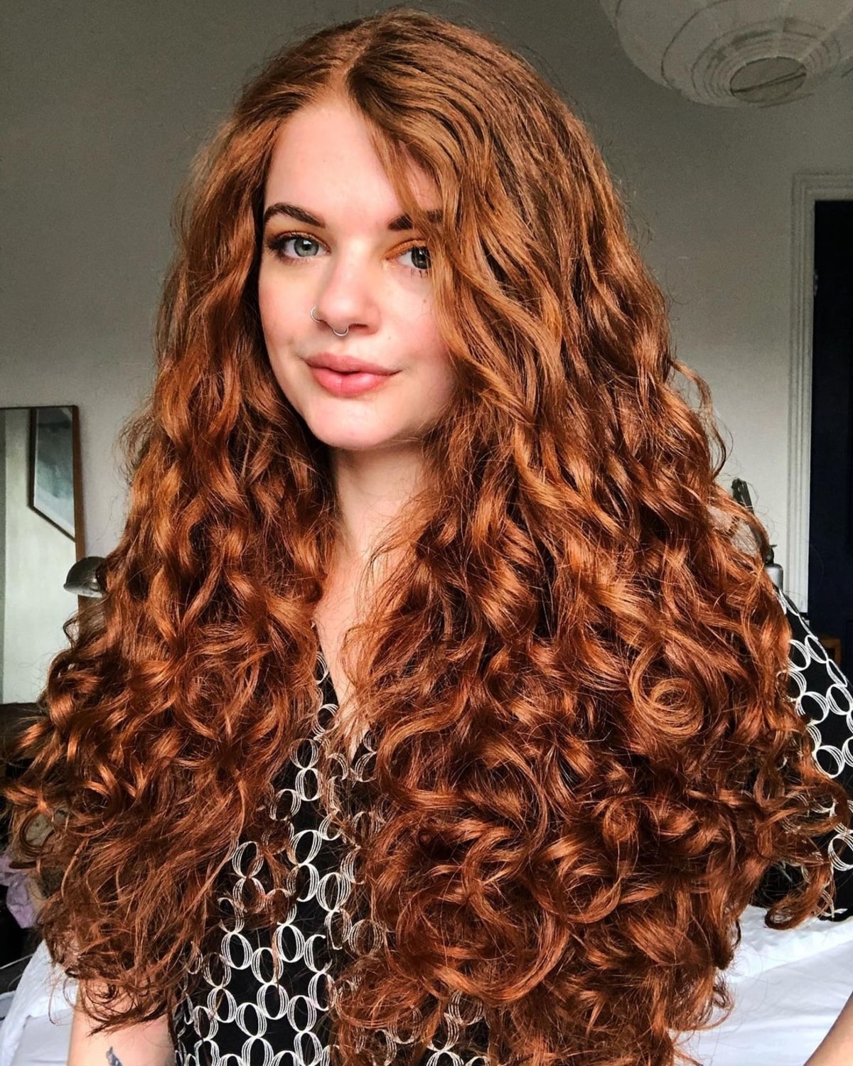 Long red curly hairstyle with large curls