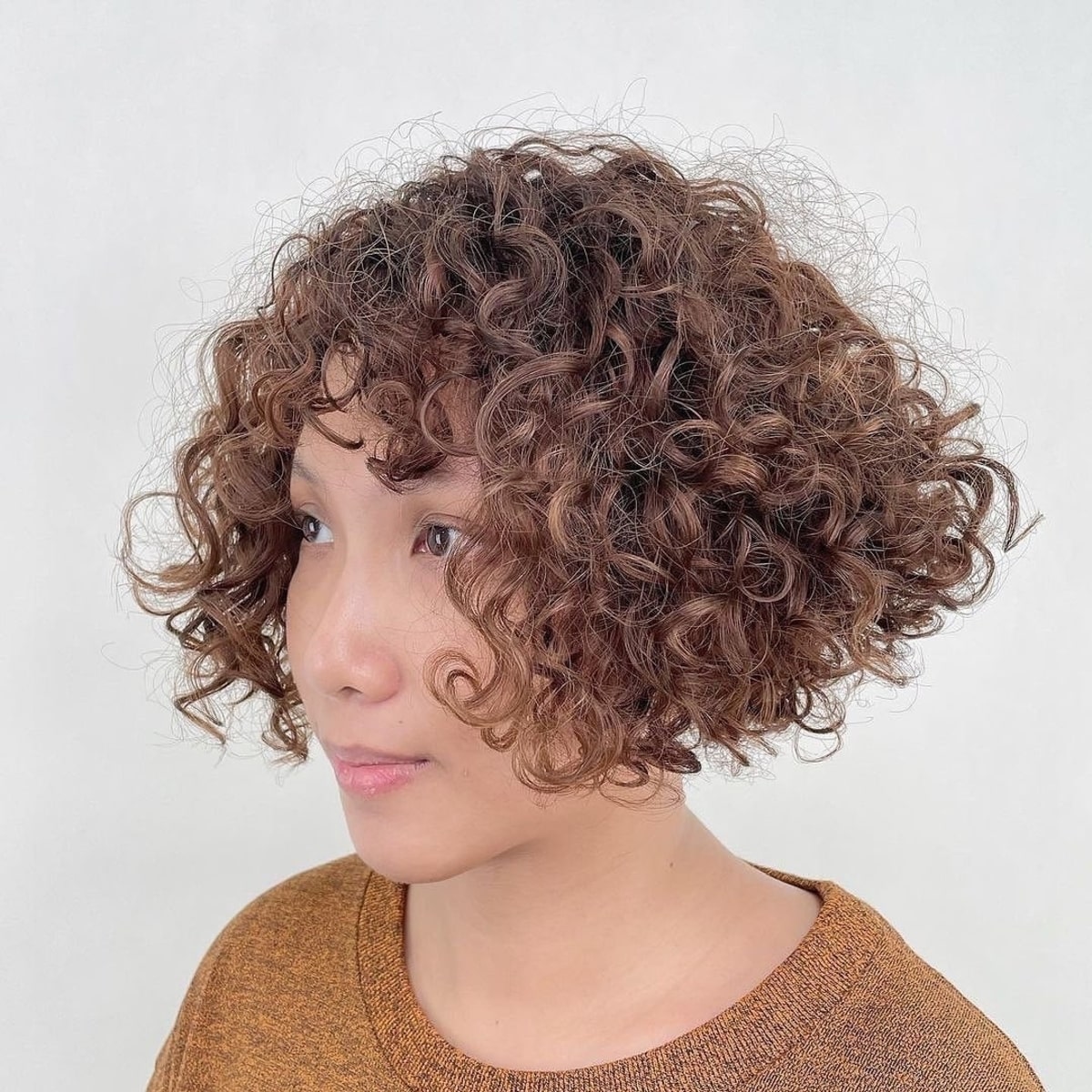 Short curly inverted bob with fringe